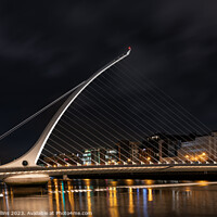 Buy canvas prints of The Samuel Beckett Bridge over the River Liffey illuminated at night  (Looking upstream from the south bank), Dublin, Ireland by Dave Collins