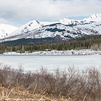 Buy canvas prints of Frozen Lower Summit lake with lakeside cabins on the Kenai Peninsular, Alaska, USA by Dave Collins