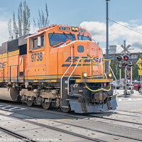 Buy canvas prints of BNSF freight train passing through Seattle along Alaskan Way highway, Seattle, USA by Dave Collins
