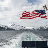 Buy canvas prints of American Stars and Stripes flag on the back of a boat in Price William Sound, Alaksa, USA by Dave Collins