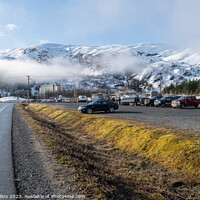 Buy canvas prints of The main car and boat trailer parking area in Whittier with the  Begich Towers Condominium building and fog and snow mountains , Whittier, Alaska, USA by Dave Collins