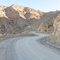 Buy canvas prints of Winding Dirt Road in the Harim Desert Mountains, Musandam, Oman by Dave Collins