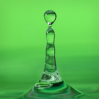 Buy canvas prints of Water droplet landing in water on a green backgrou by Dave Collins