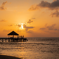 Buy canvas prints of End of Pier Sunset Party, Maldives by Dave Collins