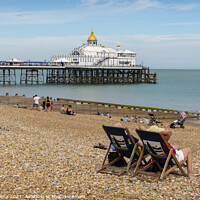 Buy canvas prints of Deck chairs on Eastbourne Beach & Pier by Dave Collins