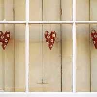 Buy canvas prints of Decorative hearts displayed inside shuttered windo by Richard Harris