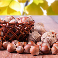 Buy canvas prints of A basket of hazelnuts on blurred background of red by Andrey Lipinskiy