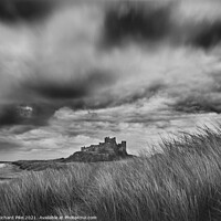 Buy canvas prints of Gathering storm over Bamburgh Castle by Richard Pike