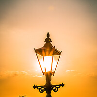 Buy canvas prints of the setting sun behind a street light in Knaresborough by mike morley