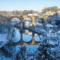 Buy canvas prints of Winter snow sunrise over the railway viaduct and river Nidd in Knaresborough, North Yorkshire.  by mike morley
