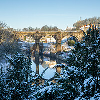 Buy canvas prints of Winter snow sunrise over the railway viaduct and river Nidd in Knaresborough, North Yorkshire.  by mike morley