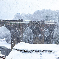 Buy canvas prints of Winter snow over the river Nidd and famous landmark railway viaduct in Knaresborough, North Yorkshire.  by mike morley