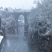 Buy canvas prints of Winter snow over the river Nidd and famous landmark railway viaduct in Knaresborough, North Yorkshire by mike morley