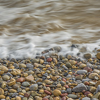 Buy canvas prints of Pebbles being washed over by the sea. by Bryn Morgan