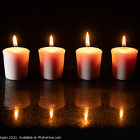 Buy canvas prints of Four burning candles with reflections by Bryn Morgan
