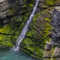 Buy canvas prints of Waterfall at Tintagel Castle in Cornwall, UK by Chris Dorney