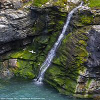 Buy canvas prints of Waterfall at Tintagel Castle in Cornwall, UK by Chris Dorney