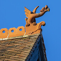 Buy canvas prints of Dragon Sculpture on a Building in Winchester, UK by Chris Dorney