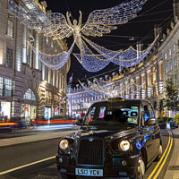 Buy canvas prints of Taxi with Regent Street Christmas Lights in London, UK by Chris Dorney