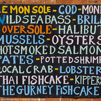 Buy canvas prints of List of Fish on the exterior of a Fishmongers in Norfolk, UK by Chris Dorney