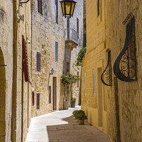 Buy canvas prints of Pretty Narrow Street in Mdina by Chris Dorney