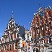 Buy canvas prints of House of the Blackheads and St. Peter's Church in Riga by Chris Dorney