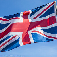 Buy canvas prints of Union Flag over a Clear Blue Sky by Chris Dorney
