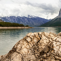 Buy canvas prints of Weathered Rock on the Shore of Lake Minnewanka  by Ann Mitchell