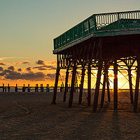 Buy canvas prints of Under the Pier at Sunset by Marg Farmer