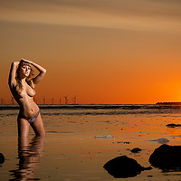 Buy canvas prints of Topless young woman at sunset standing in the sea by PAUL BAYBUT
