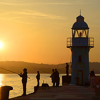 Buy canvas prints of Anglers at Brixham Breakwater Lighthouse at Dusk by Paul F Prestidge