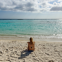 Buy canvas prints of Woman relax in front of the Caribbean Sea in Aruba by Marco Bicci