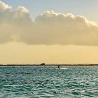 Buy canvas prints of A man practices kitesurfing at sunset by Marco Bicci