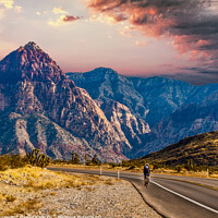 Buy canvas prints of Rider Cycling on Road Through Desert Toward Mountains by Darryl Brooks
