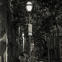 Buy canvas prints of Bicycle Chained to Black Lamp Post by Darryl Brooks