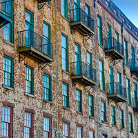 Buy canvas prints of Old Brick Building with Red and Green Windows and Balconies by Darryl Brooks