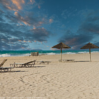 Buy canvas prints of Straw Umbrellas on Beach at Dusk by Darryl Brooks