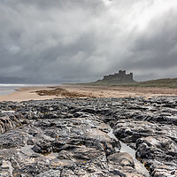 Buy canvas prints of Majestic Bamburgh Castle Amidst a Stormy Sky by James Marsden