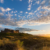 Buy canvas prints of Bamburgh Castle at Sunset by Nigel Smith