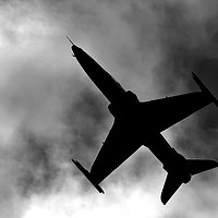 Buy canvas prints of B&W Fighter Jet Flying Overhead by Jason Jones