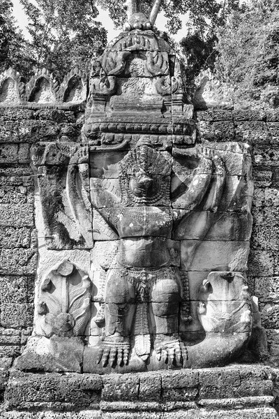 Stone carving on temple building Picture Board by Kevin Hellon