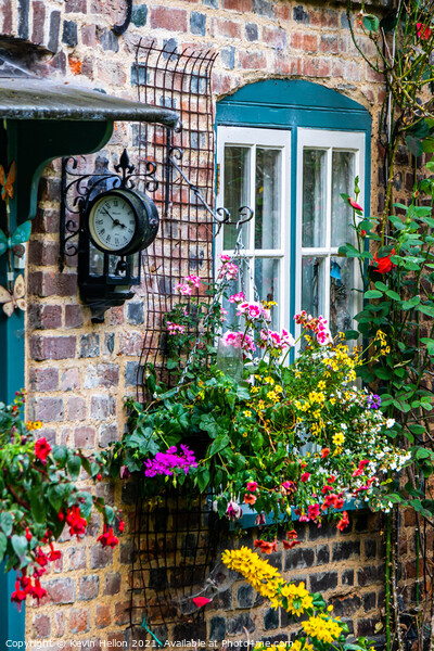 Flowers and a clock outside an English country cottage  Picture Board by Kevin Hellon