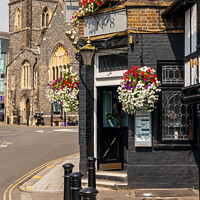 Buy canvas prints of Entrance to the Metropolitan Tavern with St Margaret's church in by Kevin Hellon