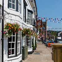 Buy canvas prints of Hanging baskets outside the Catherine Wheel pub  by Kevin Hellon
