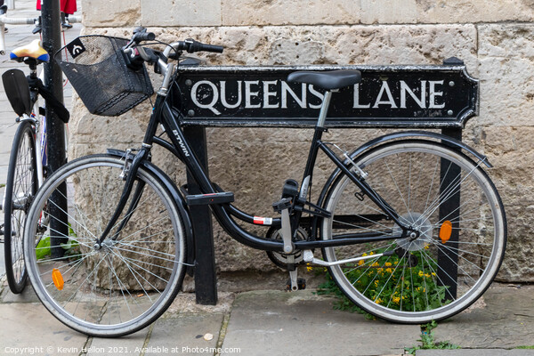 Bicycle locked to the street sign for Queen's Lane, Oxford, Picture Board by Kevin Hellon