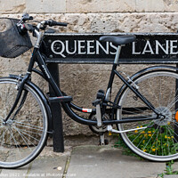Buy canvas prints of Bicycle locked to the street sign for Queen's Lane, Oxford, by Kevin Hellon