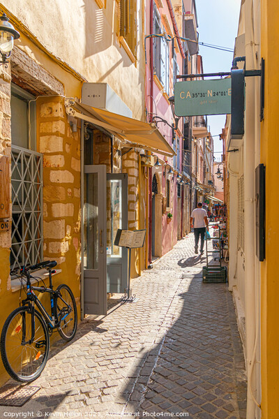 Narrow sreet in old Chania Picture Board by Kevin Hellon