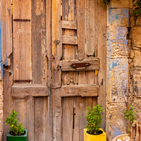 Buy canvas prints of Colourful plant containers and old wooden doors, by Kevin Hellon
