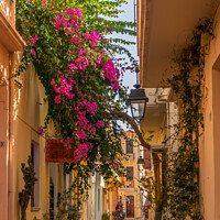 Buy canvas prints of Narrow sreet in old Rethymnon by Kevin Hellon