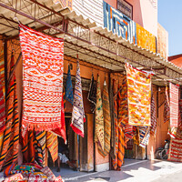 Buy canvas prints of Carpets hanging outside a shop by Kevin Hellon